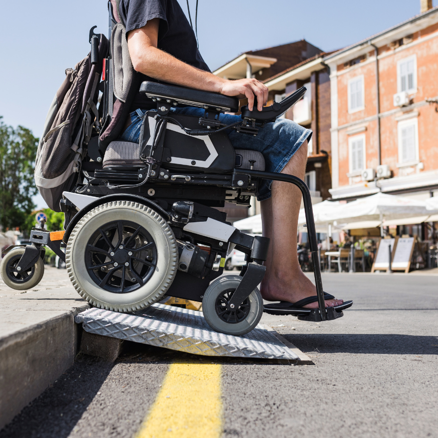Male tourist on wheelchair crossing over the threshold ramp